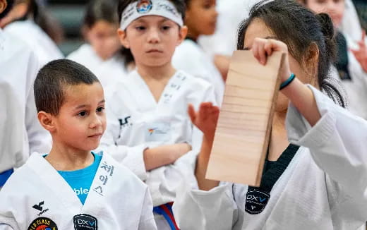 a group of boys in white karate uniforms