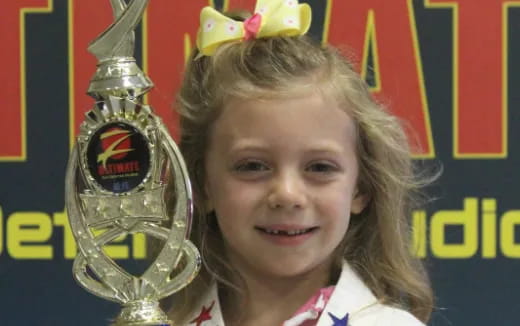 a girl holding a trophy