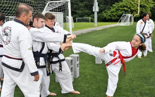 a group of people in karate uniforms
