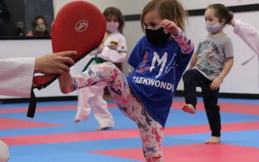 a group of children performing martial arts