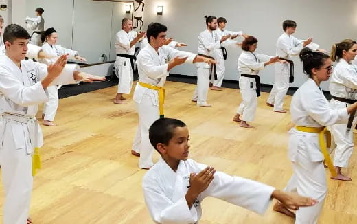 a group of people in white karate uniforms