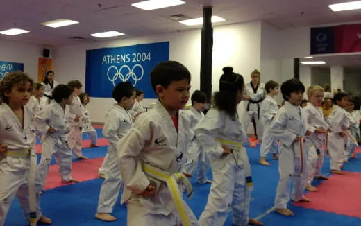 a group of children in karate uniforms