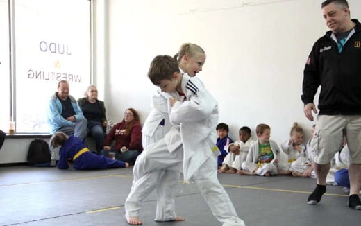 a boy and girl in karate uniforms