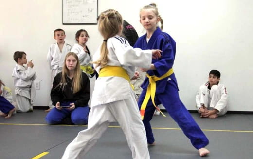 a group of people in karate uniforms