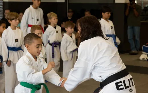 a group of children in karate uniforms