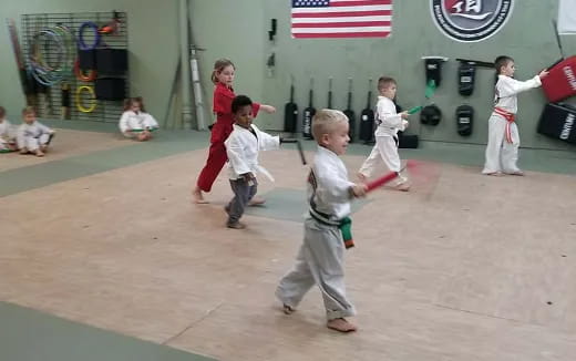 a group of kids playing baseball