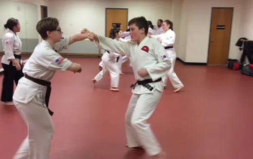 a group of people in karate uniforms