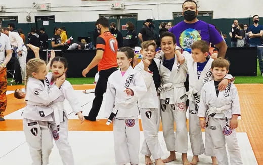 a group of kids in karate uniforms