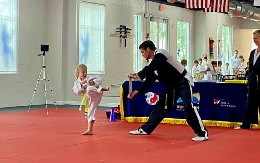 a person and a child in a karate uniform