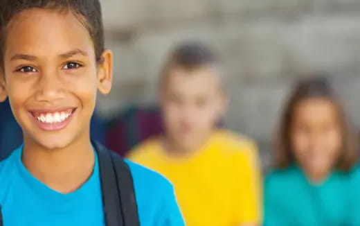 a close-up of a young boy smiling