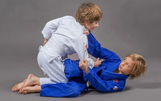 a boy and a girl in karate uniforms