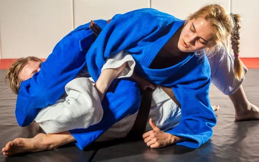 a person in blue scrubs doing push ups with a person in a white shirt