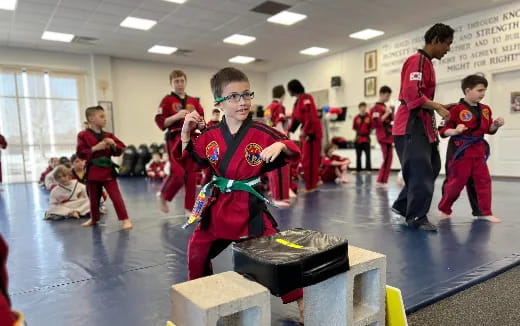 a group of kids in red karate uniforms