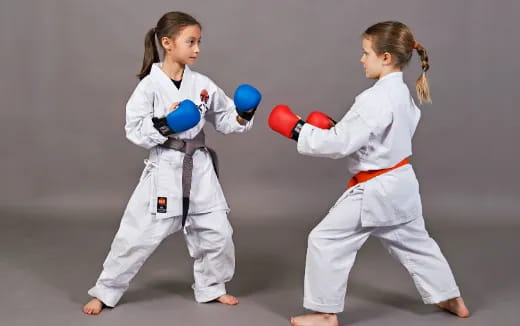 two girls in white karate uniforms