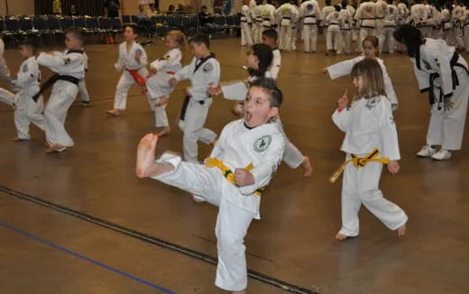 a group of children in karate uniforms