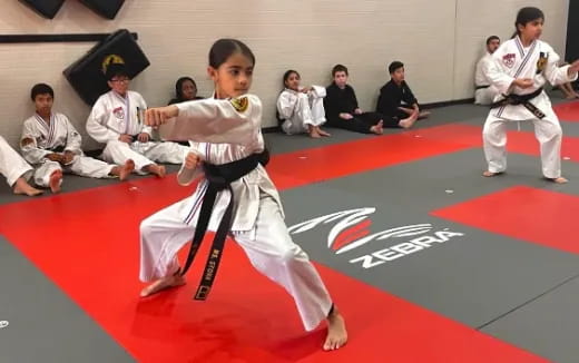 a group of people in karate uniforms