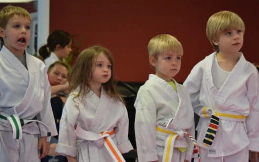 a group of children in white dresses