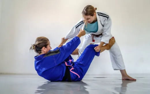 a man and a woman practicing martial arts