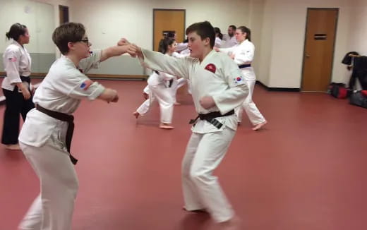 a group of people in karate uniforms