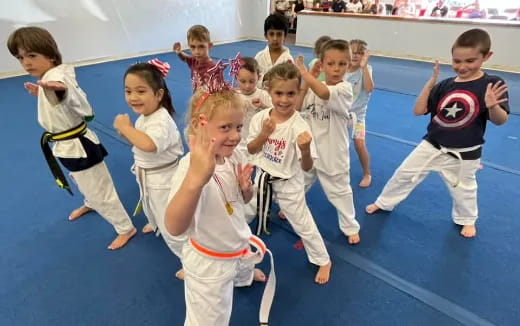 a group of children in karate uniforms