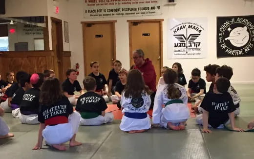a group of children sitting in a circle in a room