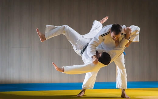 a man and a woman in karate uniforms