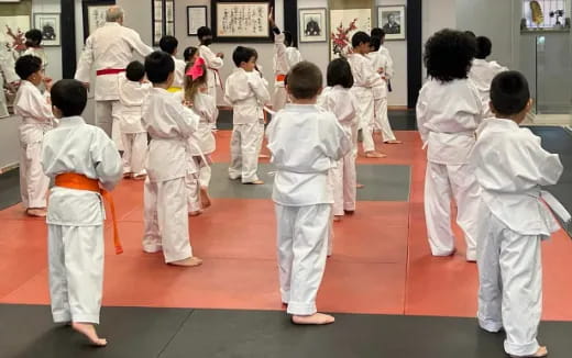 a group of children in white karate uniforms