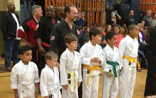 a group of children in karate uniforms