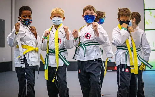 a group of boys wearing face masks