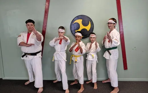 a group of people in karate uniforms