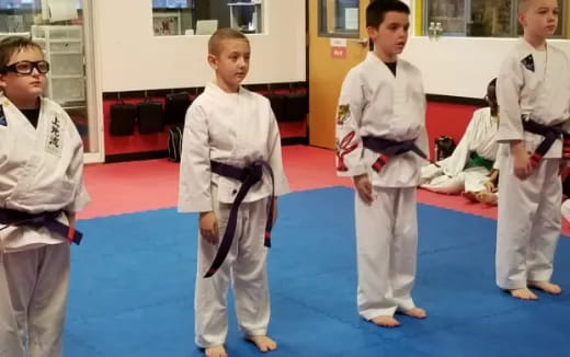 a group of children in karate uniforms