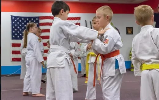 a group of children in karate uniforms