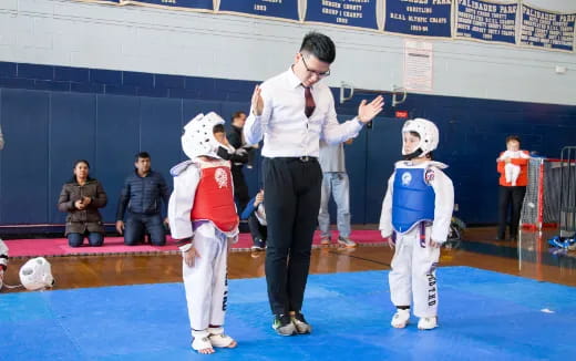 a man standing in front of a group of kids in clothing