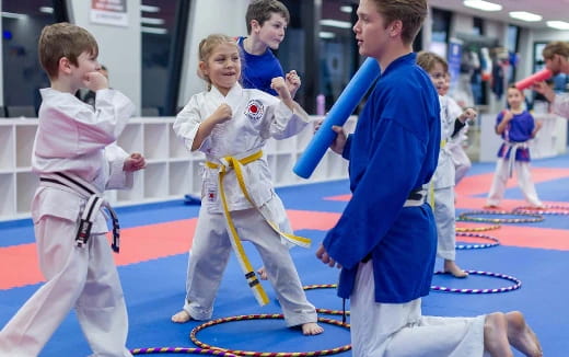 a group of children in karate uniforms
