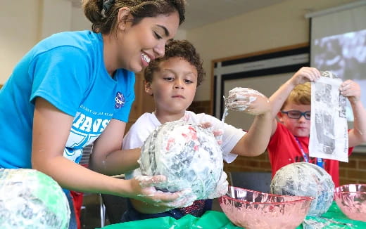a person and a child in a room with food
