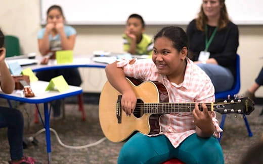 a person playing a guitar