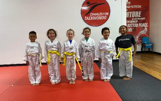 a group of children in karate uniforms