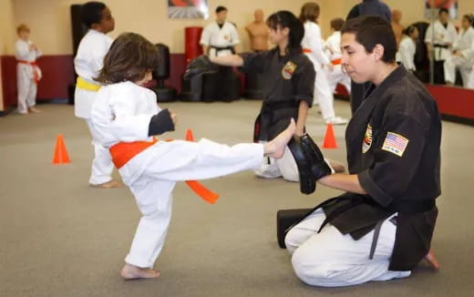 a man and a woman in karate uniforms