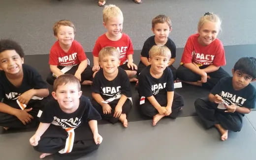 a group of boys sitting on the floor