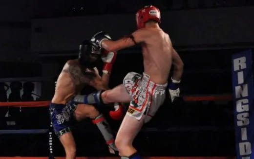 a man punching another man in a boxing ring