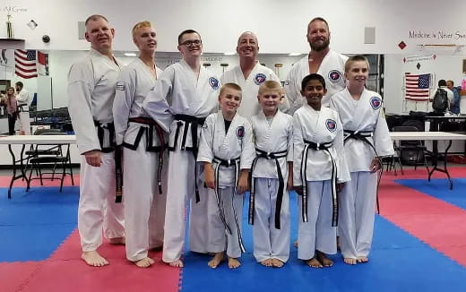 a group of people in karate uniforms