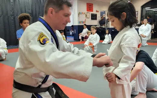 a man and a woman in karate uniforms