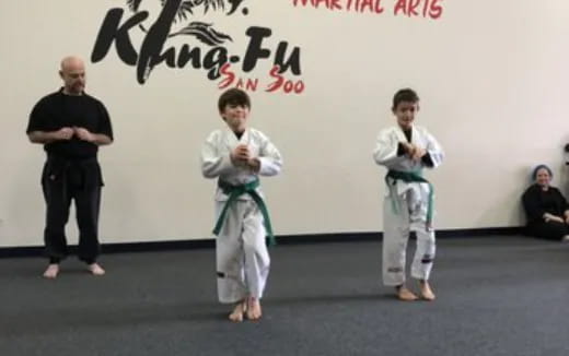 a group of people in karate uniforms