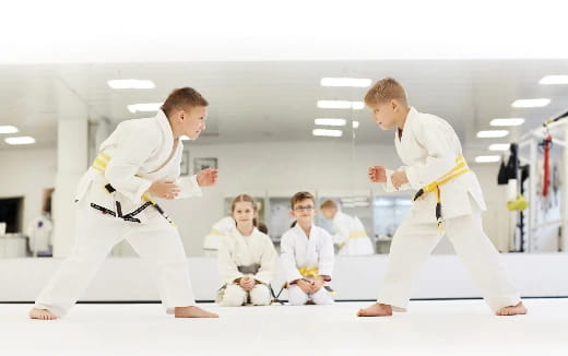 a group of people in karate uniforms