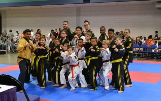 a group of people in karate uniforms