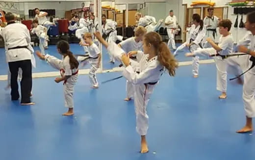 a group of people in karate uniforms