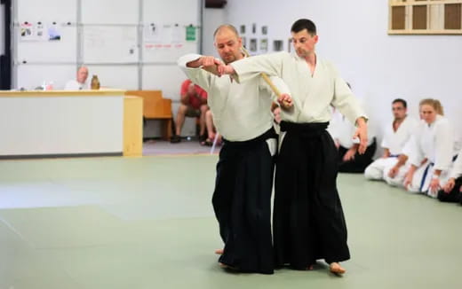 a person in a white robe and a person in a black robe