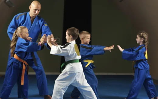 a group of people in blue karate uniforms