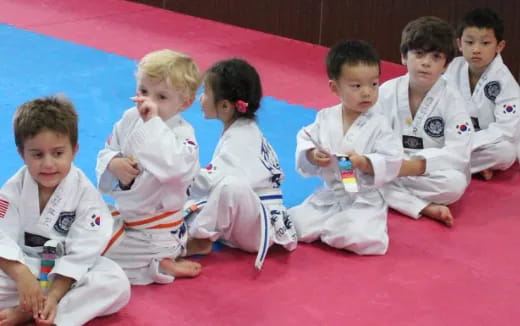 a group of children in karate uniforms
