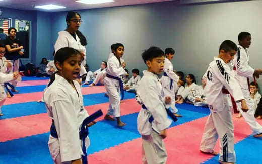 a group of children in karate uniforms
